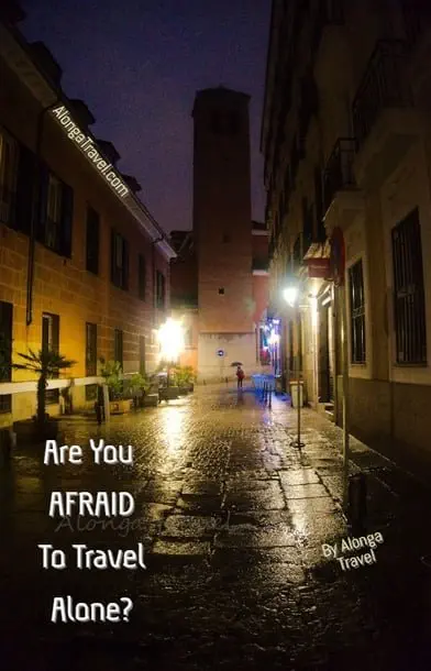 A dark alley in Madrid & a custom sign: 'Afraid to travel alone?'