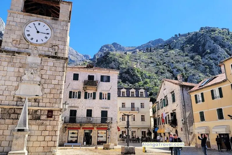 Clock tower in Kotor on Old Town Square is a center of outdoor restaurants & evening activities.