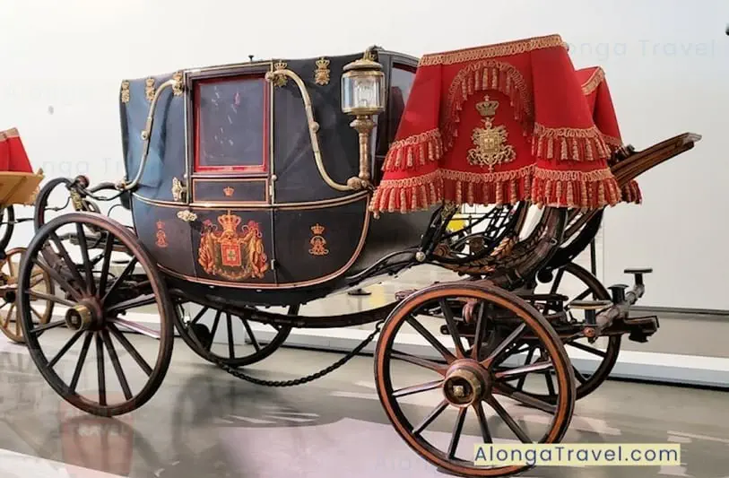 Black old horse-drawn carriage with a Royal emblem from the National Coach Museum in Lisbon