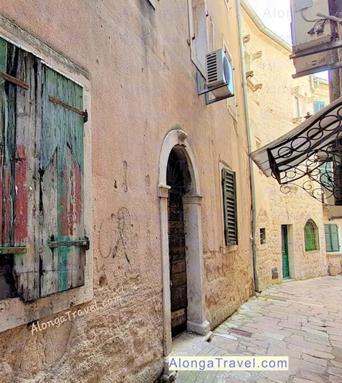 A winding street in Old town Kotor with mediaeval houses & cobblestone pavement