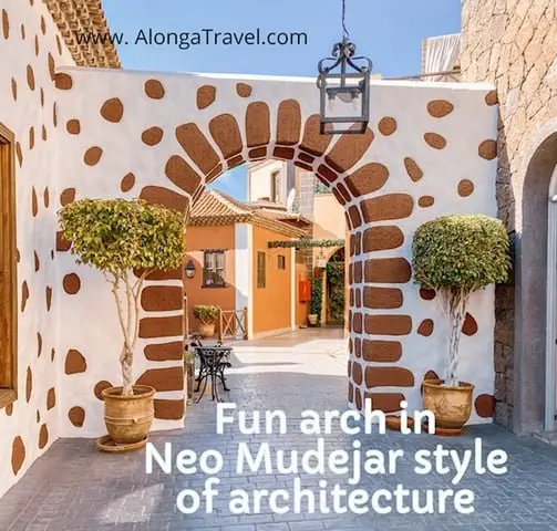 Fun looking colorful white arch with brown brick looking stones