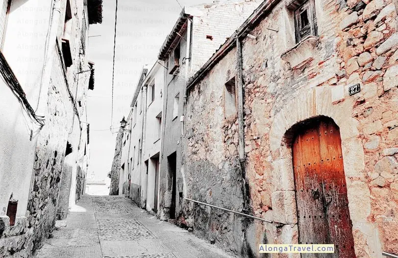 an old alley with a house with ancient red door in L'Espluga de Francoli