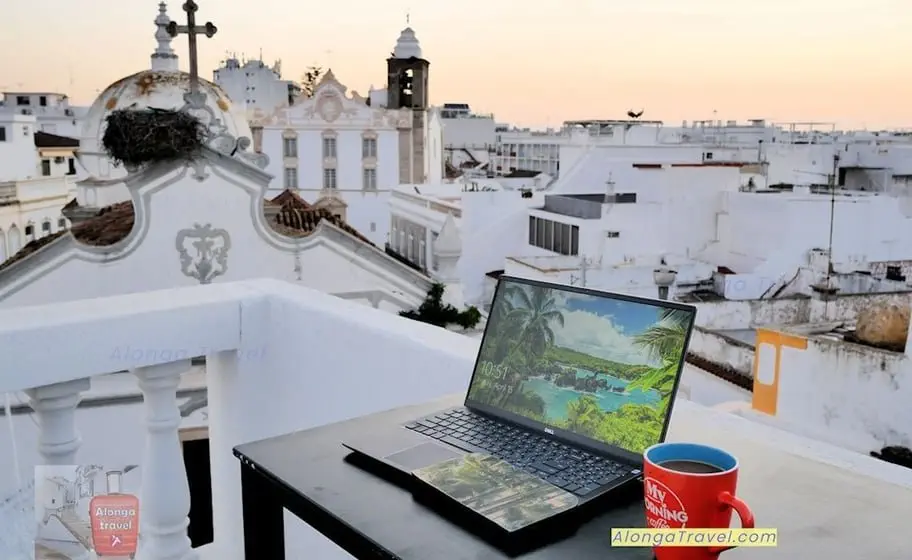 my travel office on a rooftop with a laptop for my on-line job assignment on my nomadic solo life