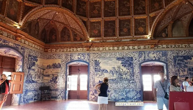 Blue tiled panels with scenes of the Royal hunt & a brown carved ceiling in Sintra Royal Palace