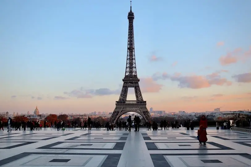 Eiffel Tower hovers over skyline of Paris, a place to fly cheaply into in Europe