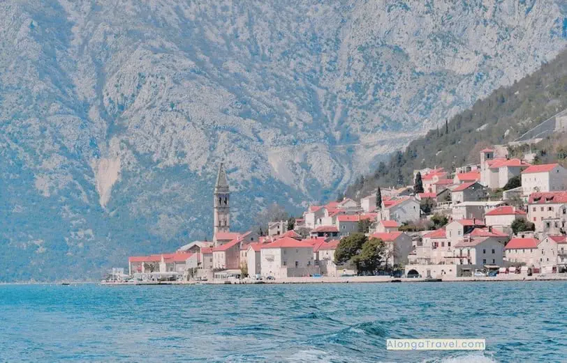 red roofs of Perast town near Kotor & steep â›° as a backdrop as seen from my boat