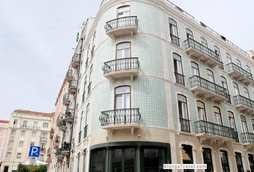 Ornate green wrought iron balconies on a Pombaline building covered with green azulejos