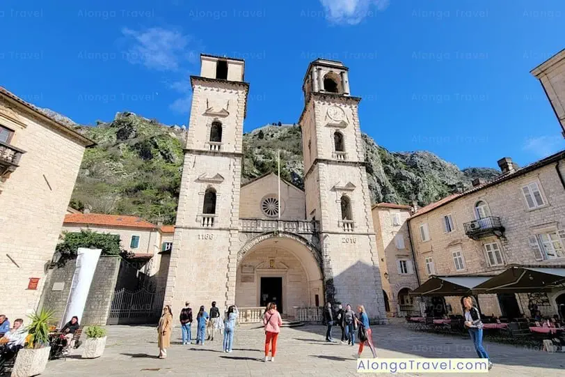 Saint Tryphon's Cathedral against a â›° backdrop & a busy square in front of it is one of the must-see