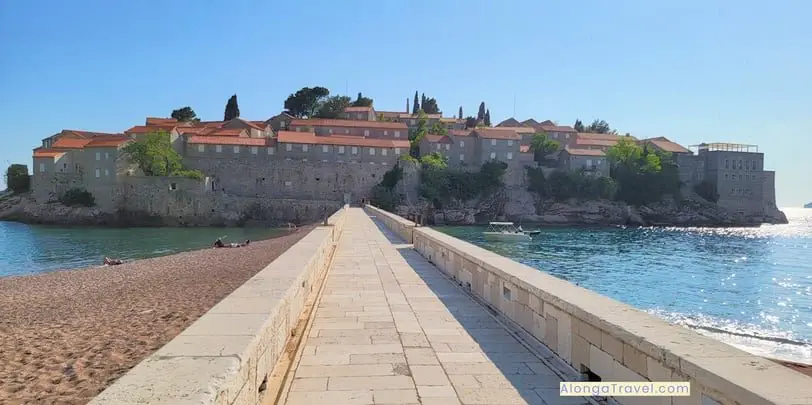 An oval medieval island of Sveti Stefan with a narrow road leading to there, surrounded by the sea