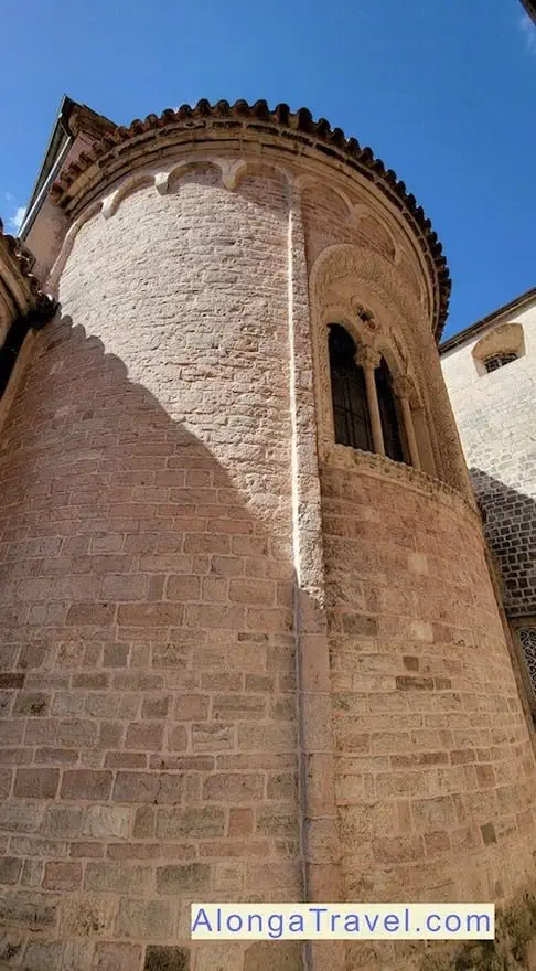 Round old tower with quatrefoils at the back of Saint Luke's church in Old Town Kotor