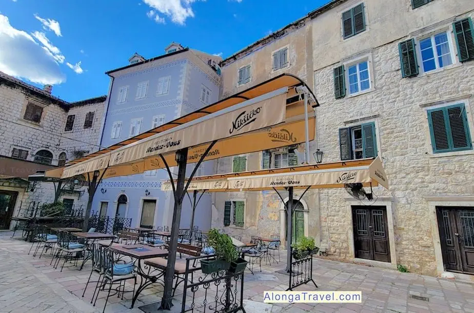 Beautiful old small square with outdoor restaurant tables in Old town Kotor