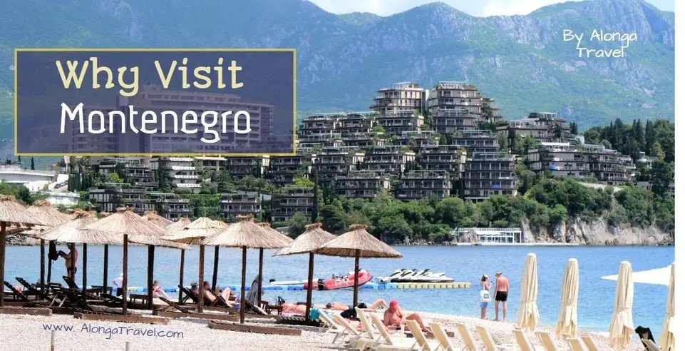 A beach with sun umbrellas and a view of luxury resort across the sea bay