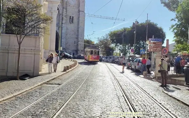 Tram 28 basking in sunshine in front of Lisbon Cathedral