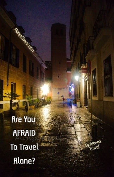A dark alley in Madrid & a custom sign: 'Afraid to travel alone?'