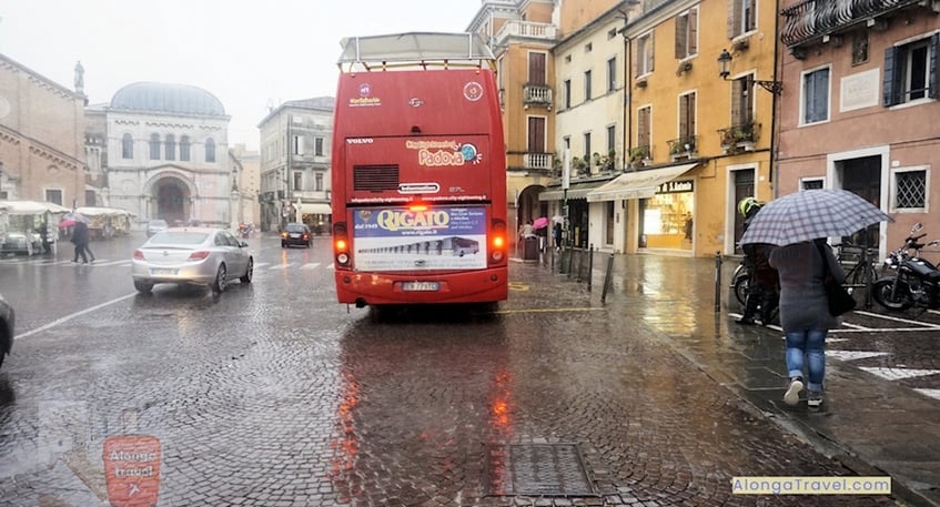 City lights reflecting in puddles of rain in Padua, Italy - a popular travel destination
