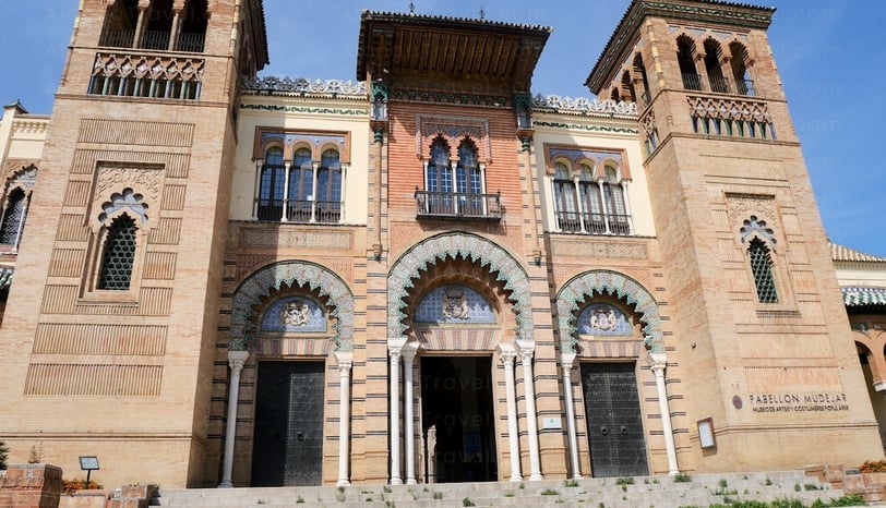 Intricate blue archways of Mudejar Pavilion in Maria Luisa Park, Seville