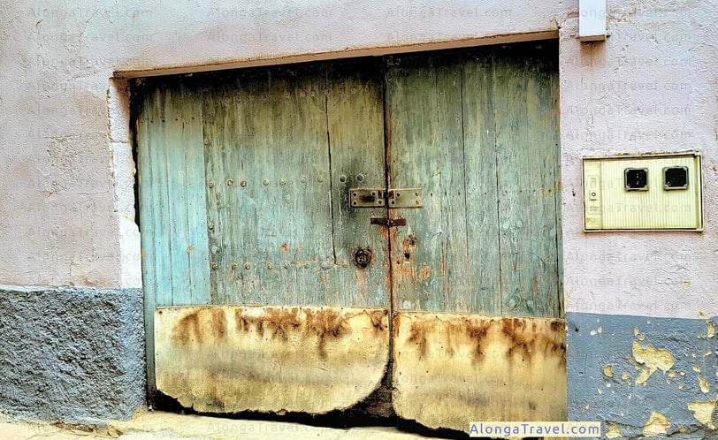 A beautiful green old wooden medieval two sided door to an old house in L'Espluga de Francoli