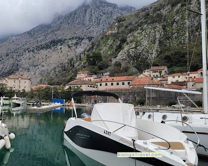 A few boats in Kotor bay in front of majestic looking ⛰ & Kotor sitting at the bottom of the ⛰
