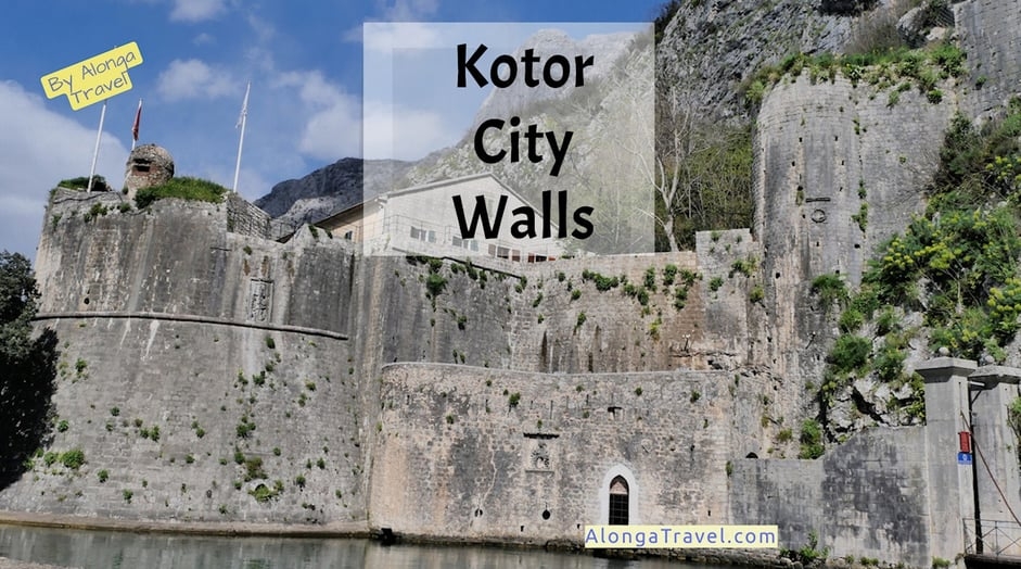Medieval round fortress over a pond & a custom sign: 'Kotor city walls'