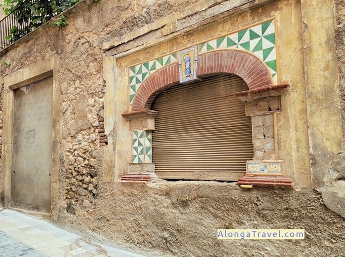An exquisite arched window framed with bricks and tiles in Espluga