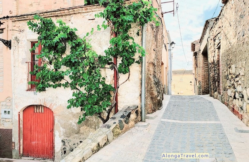 Beautiful old rounded red door in stone medieval house in Espluga de Franco