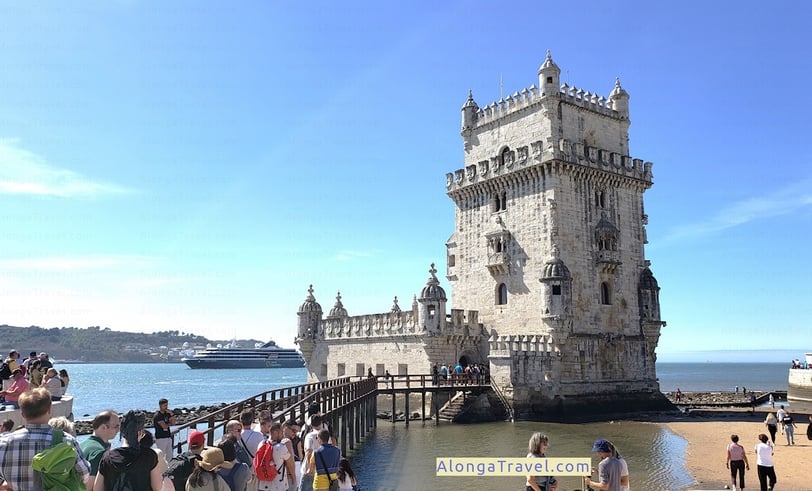 Gray square Belem Tower stands on the river edge in Lisbon