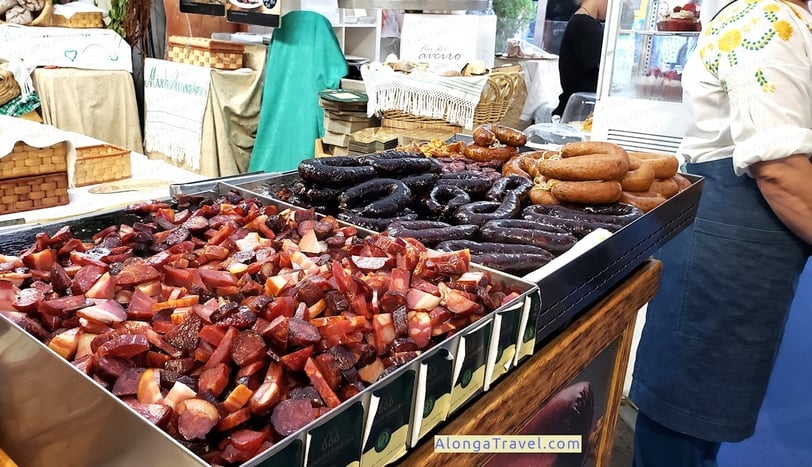 metal beans at farmers market in Lisbon full of cooked sausage samples