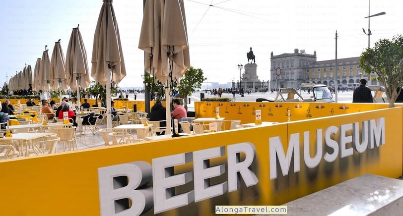 People sitting at the tables in Beer Museum, overlooking the Square of Commerce