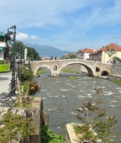 An old bridge across a narrow river in Prizren, Kosovo