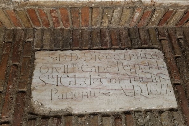 medieval writing on a panel in front of Saint Barthélemy church