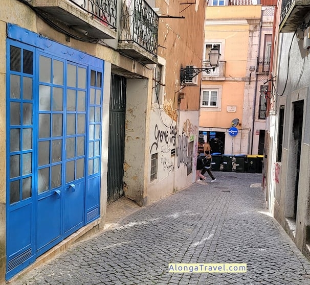 a person walking down a cobblestone street