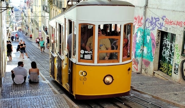 Yellow crowded elevator Bica climbs Rue da Bica in Chiado Lisbon